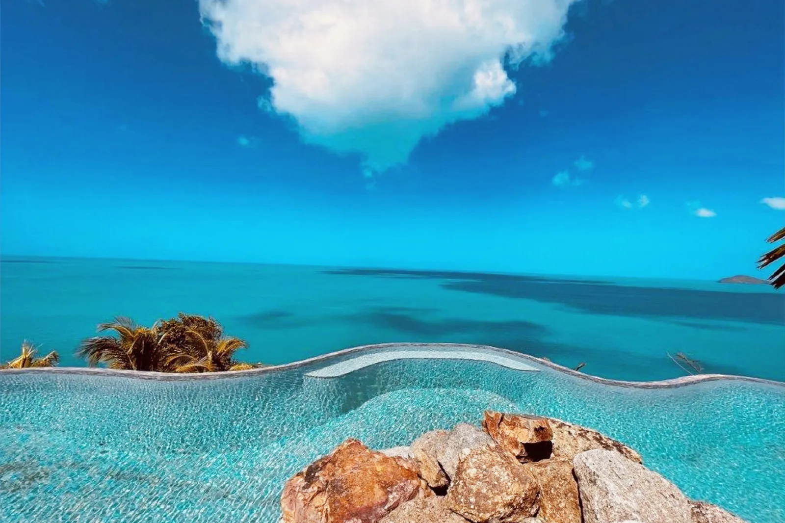 Round infinity pool framed by palm trees, Villa MyALL Tortola